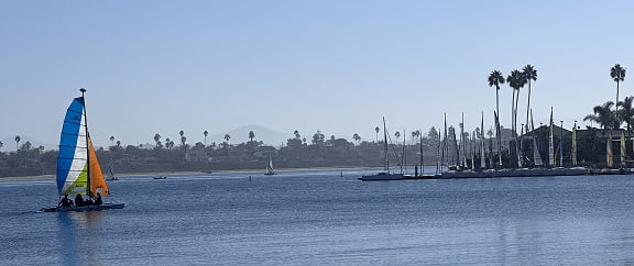 Photo that I took while enjoying my Saturday on Mission Bay in San Diego, California. The photo shows the blue waters of the bay, a clear sky, and a small boat cruising the water.